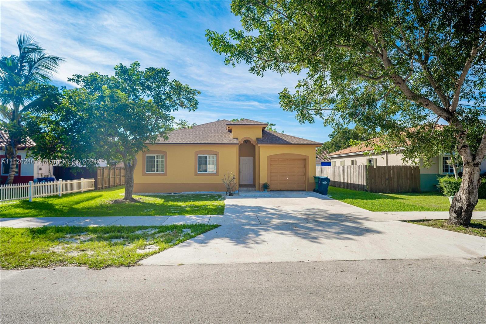 19064 Southwest 319th Street Homestead, FL 33030 - Photo 1 of 15 a front view of a house with a yard and garage