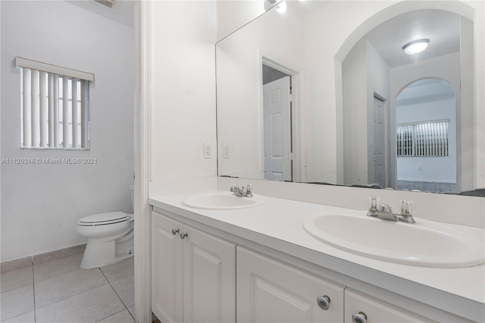19064 Southwest 319th Street Homestead, FL 33030 - Photo 12 of 15 a bathroom with a sink and a toilet