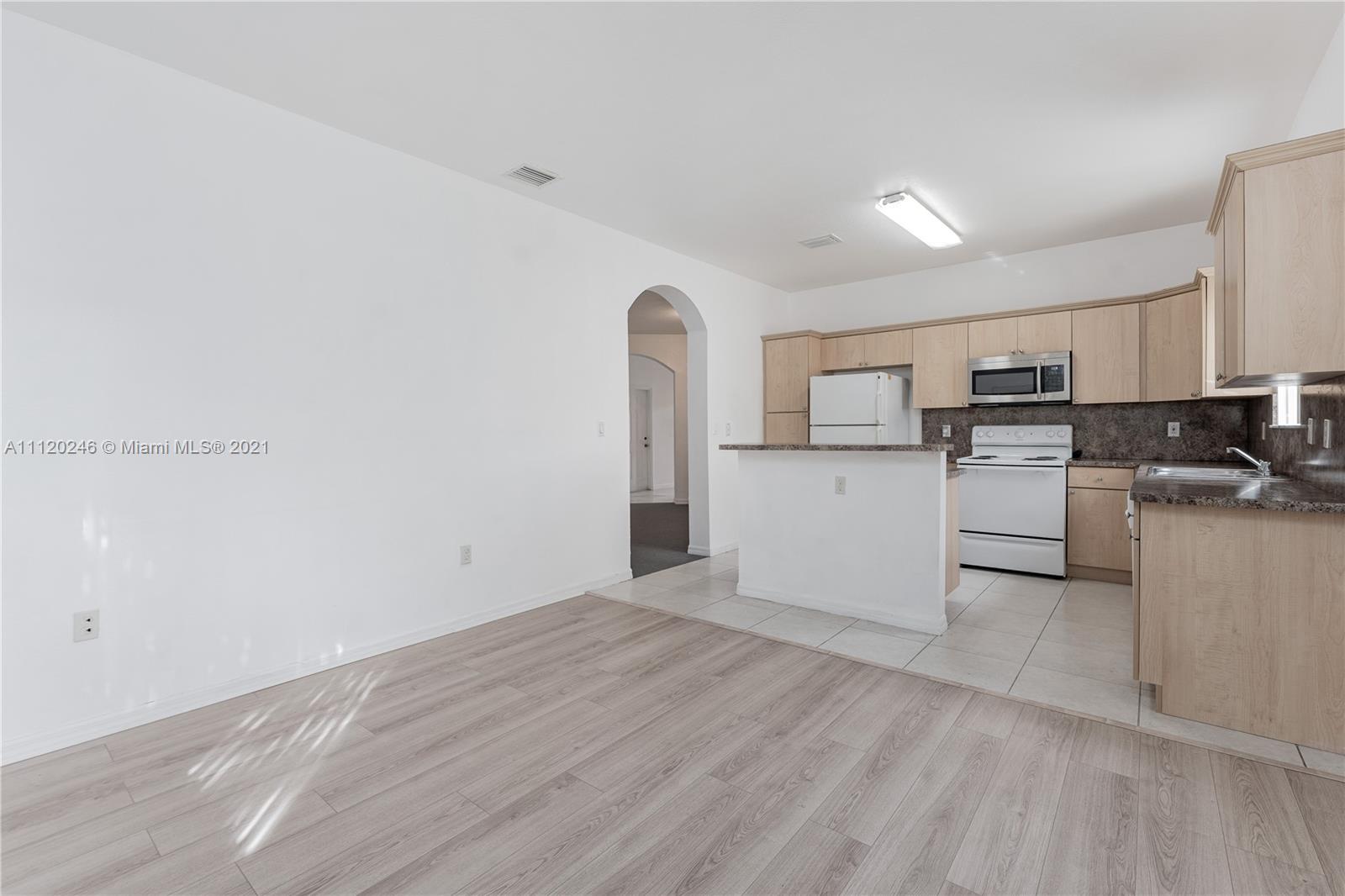 19064 Southwest 319th Street Homestead, FL 33030 - Photo 5 of 15 a view of a kitchen with microwave and cabinets