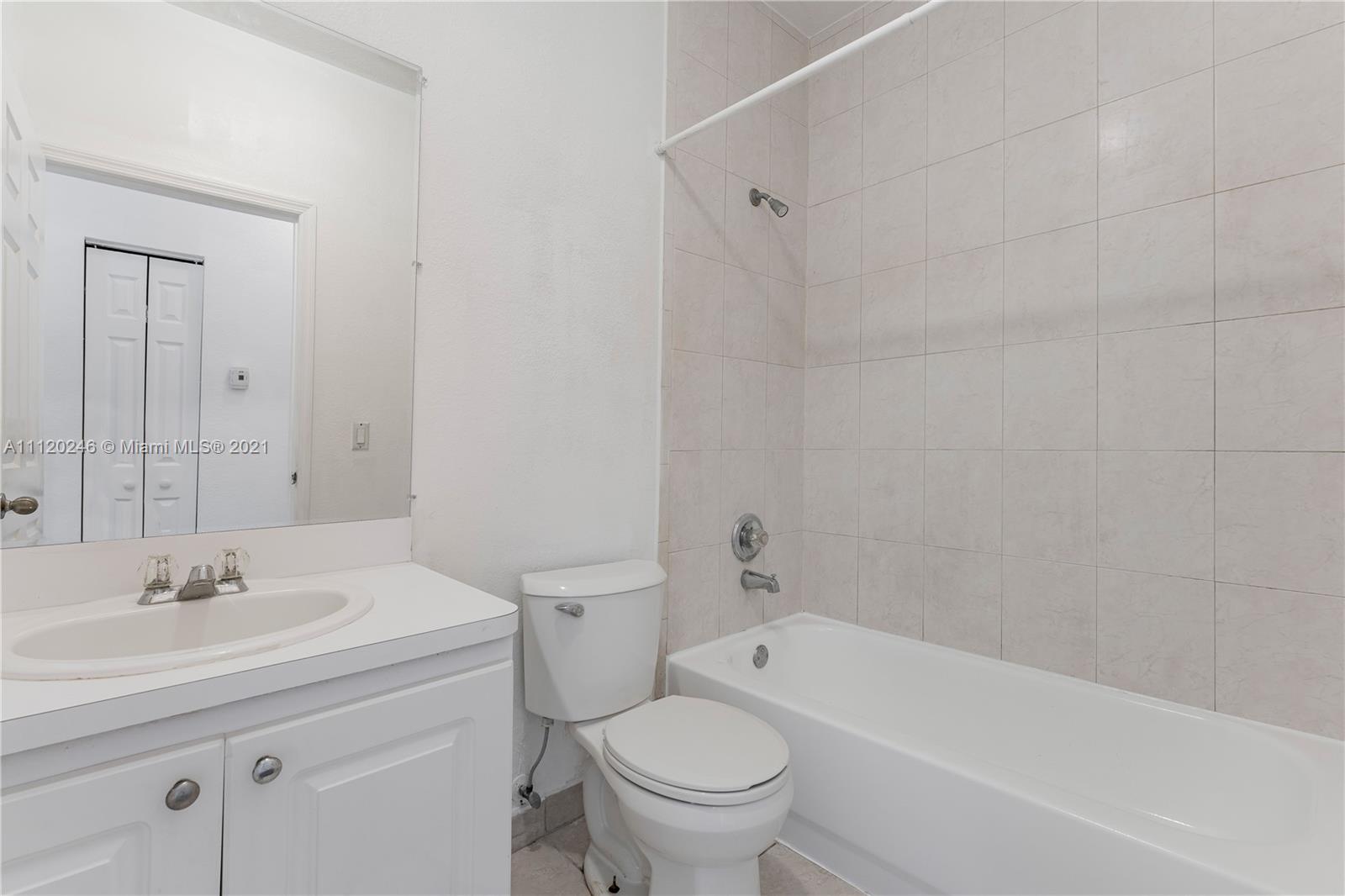 19064 Southwest 319th Street Homestead, FL 33030 - Photo 8 of 15 a bathroom with a sink a toilet and a bathtub