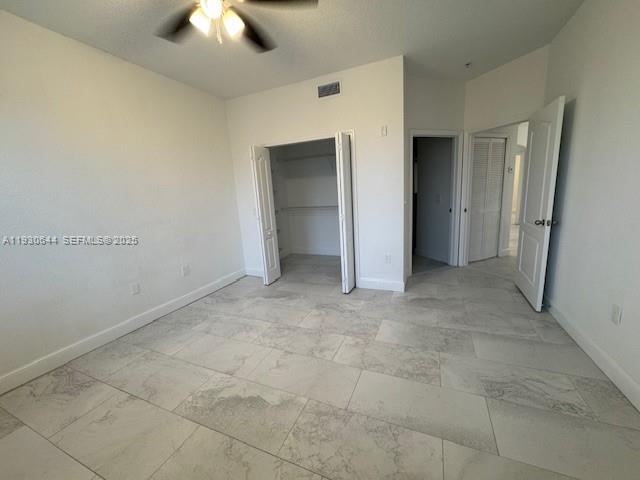11033 Legacy Boulevard, Unit 302 Palm Beach Gardens, FL 33410 - Photo 11 of 28 a view of an empty room and chandelier fan