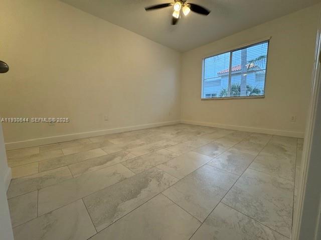 11033 Legacy Boulevard, Unit 302 Palm Beach Gardens, FL 33410 - Photo 16 of 28 an empty room with a chandelier fan and windows