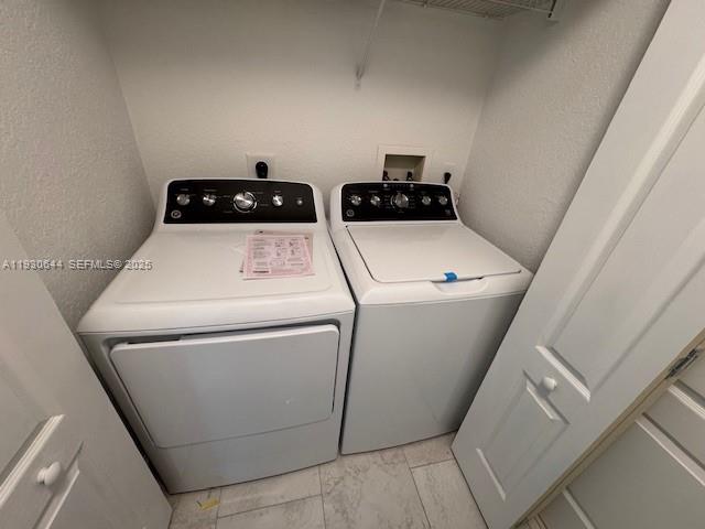 11033 Legacy Boulevard, Unit 302 Palm Beach Gardens, FL 33410 - Photo 20 of 28 a utility room with dryer and washer