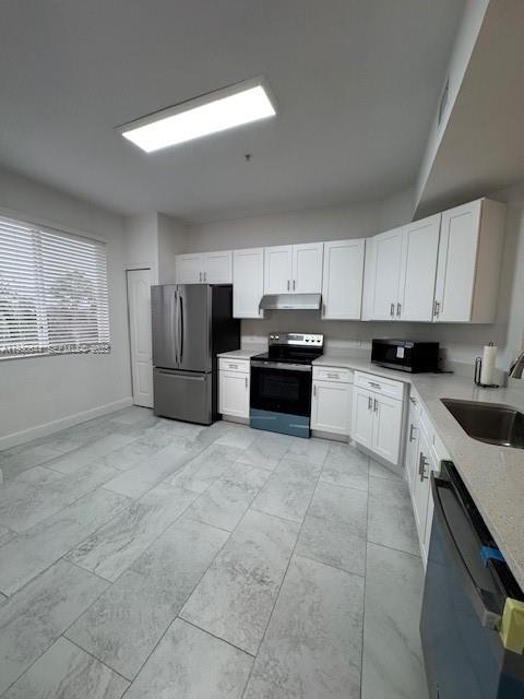 11033 Legacy Boulevard, Unit 302 Palm Beach Gardens, FL 33410 - Photo 7 of 28 a large kitchen with cabinets and stainless steel appliances