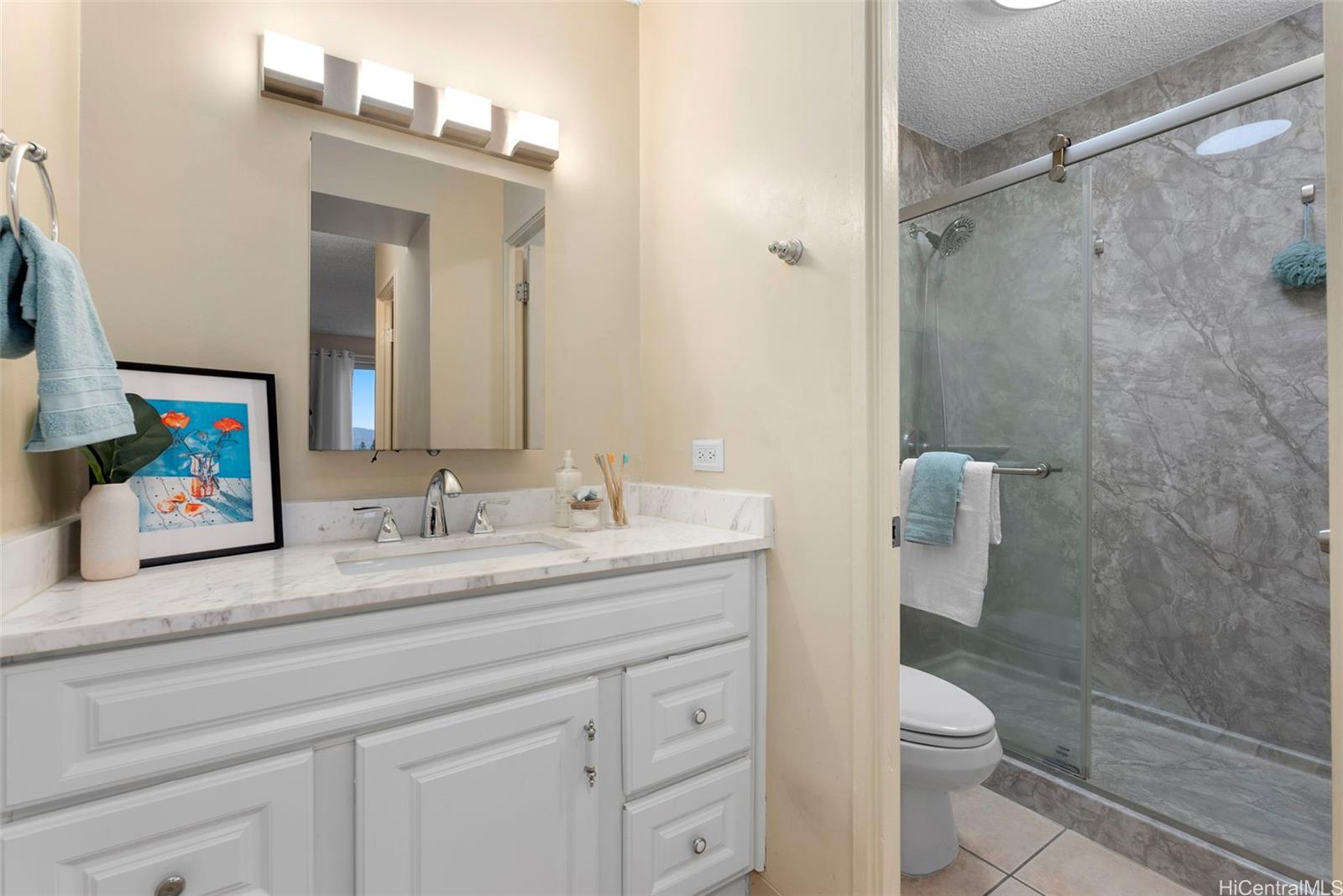 98-1038 Moanalua Road, Unit 1502 Aiea, HI 96701 - Photo 14 of 20 a bathroom with a sink a toilet and shower