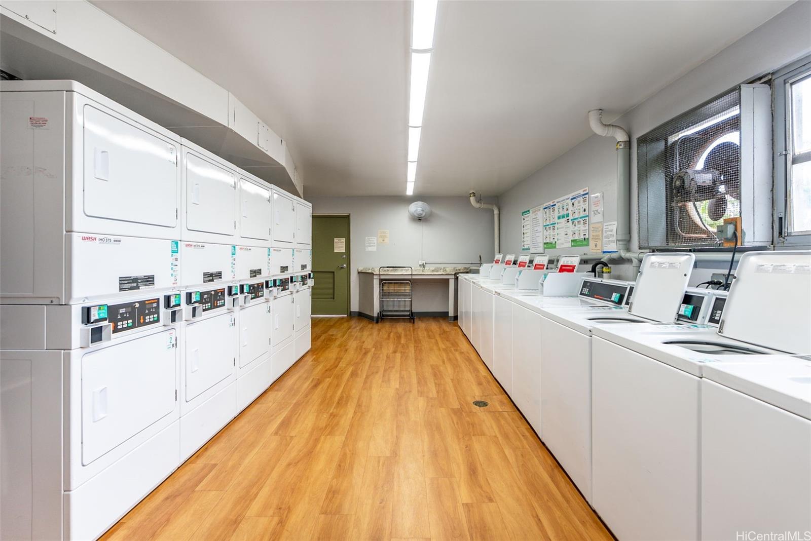 98-1038 Moanalua Road, Unit 1502 Aiea, HI 96701 - Photo 20 of 20 a kitchen with kitchen island wooden floor center island and appliances