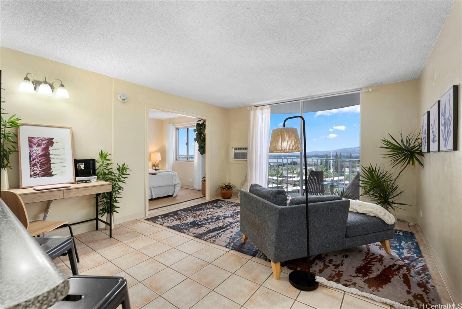 98-1038 Moanalua Road, Unit 1502 Aiea, HI 96701 - Photo 2 of 20 a living room with furniture a dining table and a potted plant