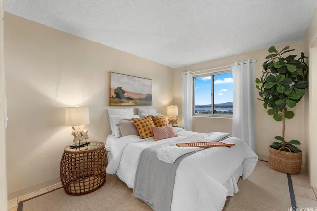 a bedroom with a bed and a potted plant