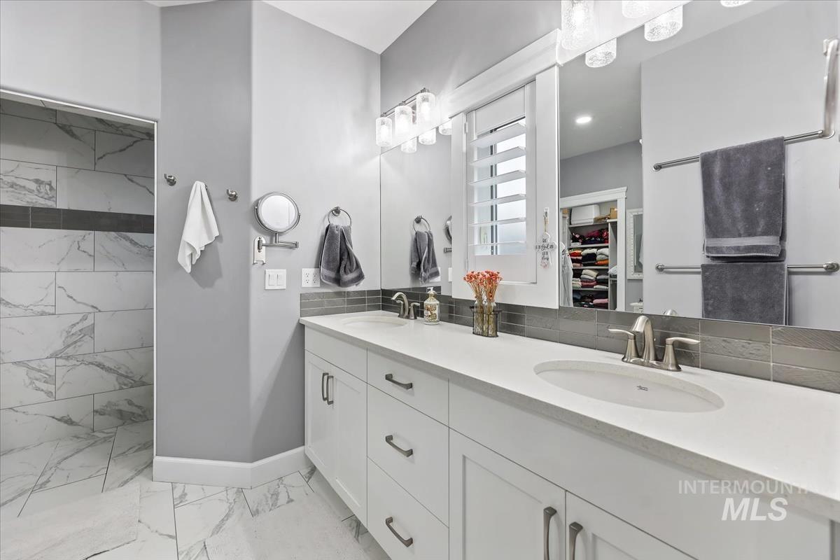 189 South Devon Avenue Star, ID 83669 - Photo 13 of 42 Full bath featuring double vanity, light marble finish floors, and a walk in closet