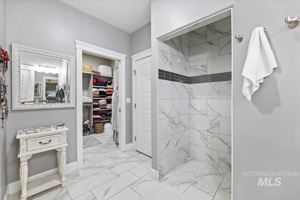 189 South Devon Avenue Star, ID 83669 - Photo 15 of 42 Bathroom with light marble finish flooring, a marble finish shower, and a spacious closet