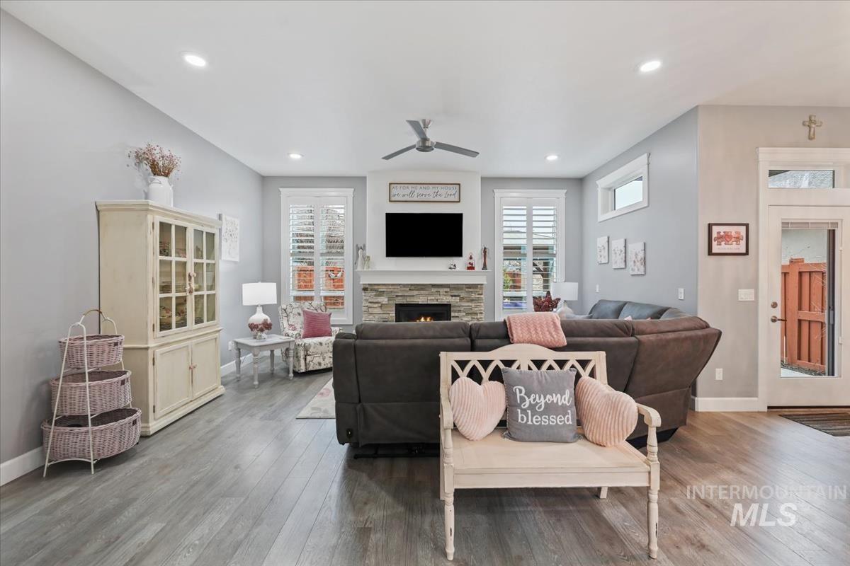 189 South Devon Avenue Star, ID 83669 - Photo 19 of 42 Living room featuring ceiling fan, wood-type flooring, a stone fireplace, and recessed lighting