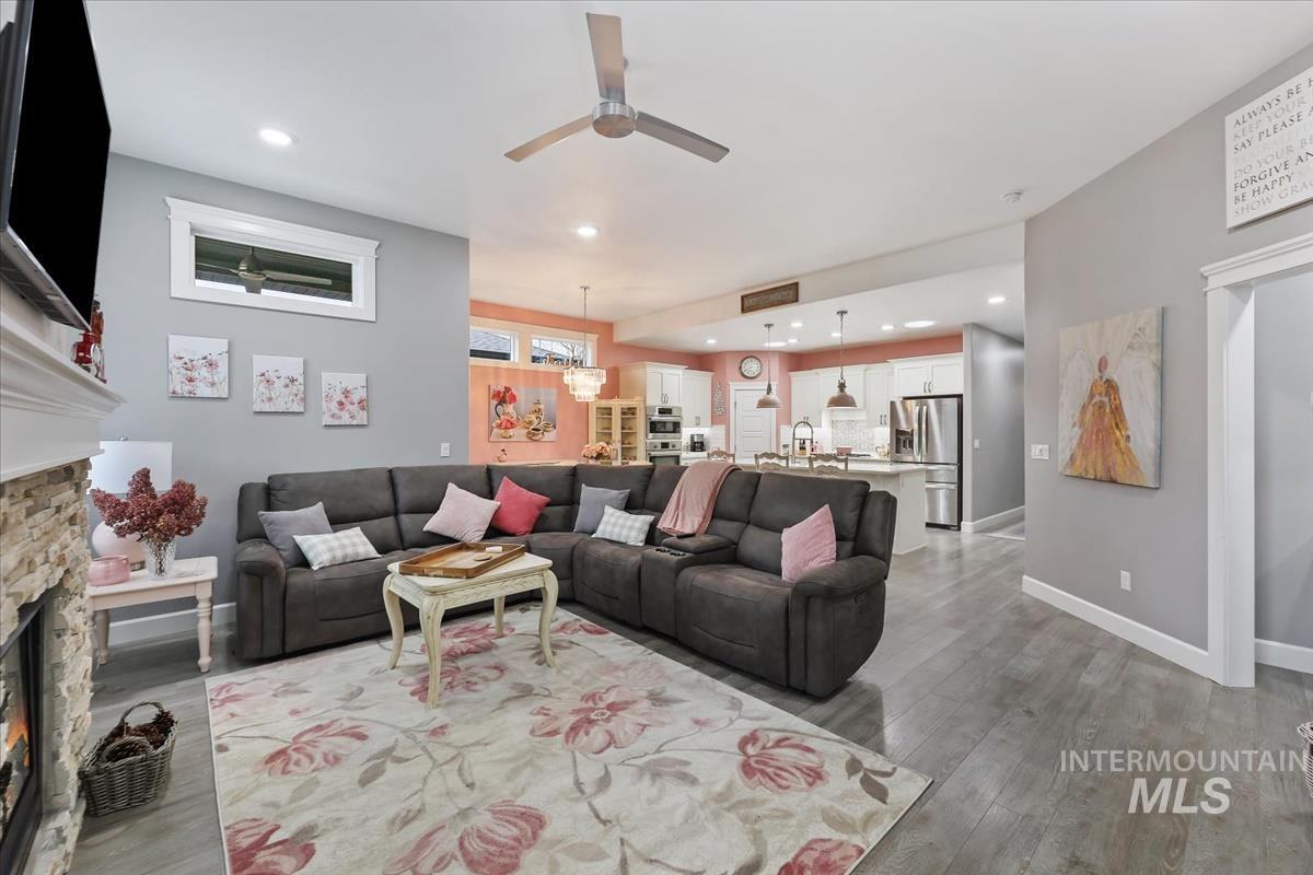 189 South Devon Avenue Star, ID 83669 - Photo 21 of 42 Living room featuring a fireplace, recessed lighting, a ceiling fan, and wood finished floors