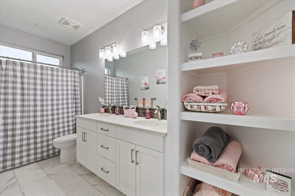 189 South Devon Avenue Star, ID 83669 - Photo 24 of 42 Bathroom with double vanity, light marble finish floors, and a shower with curtain