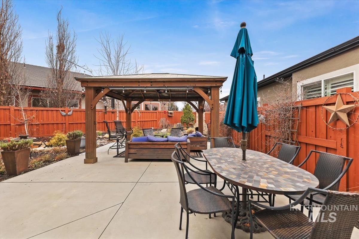 189 South Devon Avenue Star, ID 83669 - Photo 27 of 42 Fenced backyard with a gazebo, outdoor lounge area, outdoor dining area, and a patio