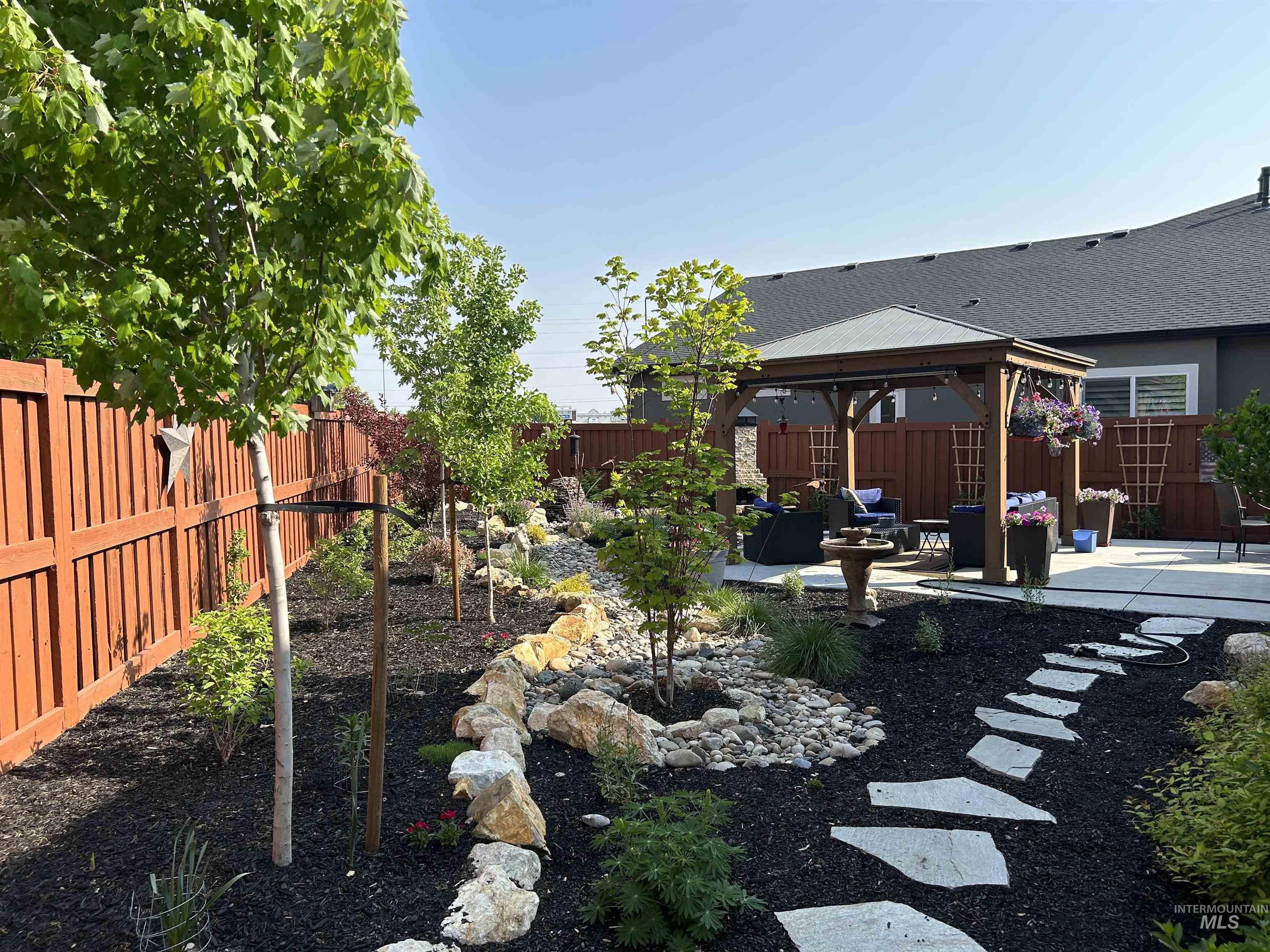 189 South Devon Avenue Star, ID 83669 - Photo 28 of 42 Fenced backyard with a gazebo, a patio area, and outdoor lounge area
