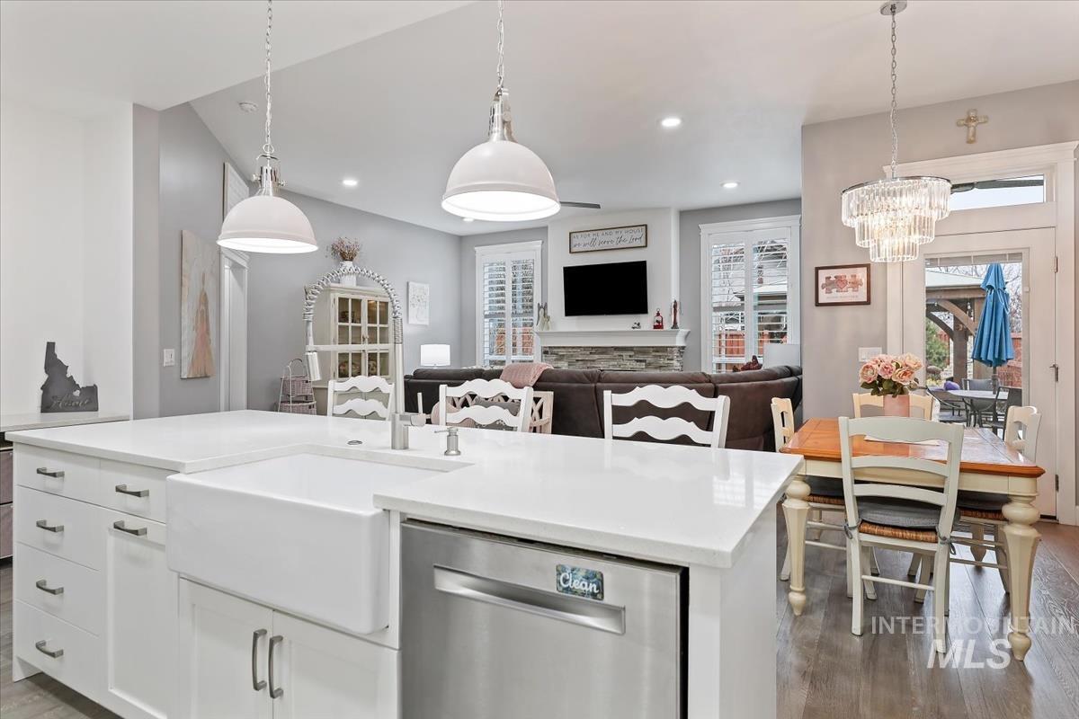 189 South Devon Avenue Star, ID 83669 - Photo 3 of 42 Kitchen featuring decorative light fixtures, dishwasher, dark wood-type flooring, white cabinets, and an island with sink