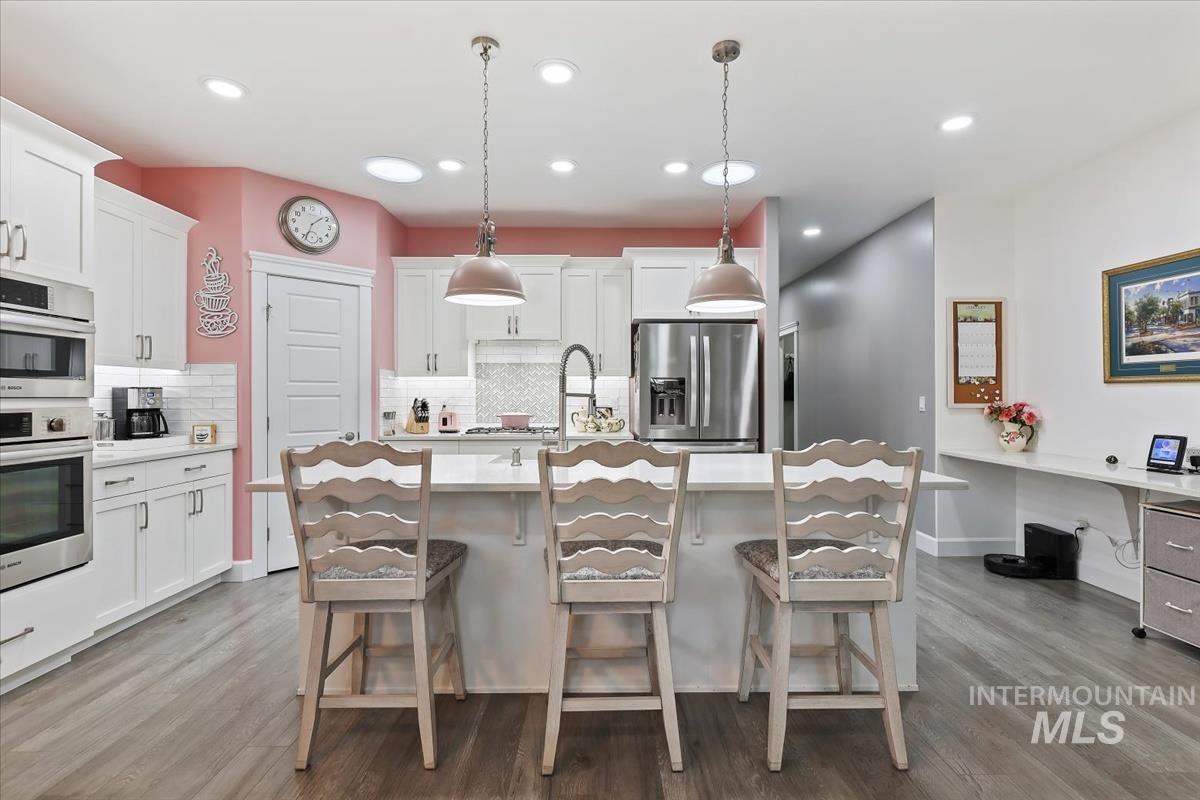 189 South Devon Avenue Star, ID 83669 - Photo 4 of 42 Kitchen with a kitchen breakfast bar, pendant lighting, white cabinetry, appliances with stainless steel finishes, and a kitchen island with sink