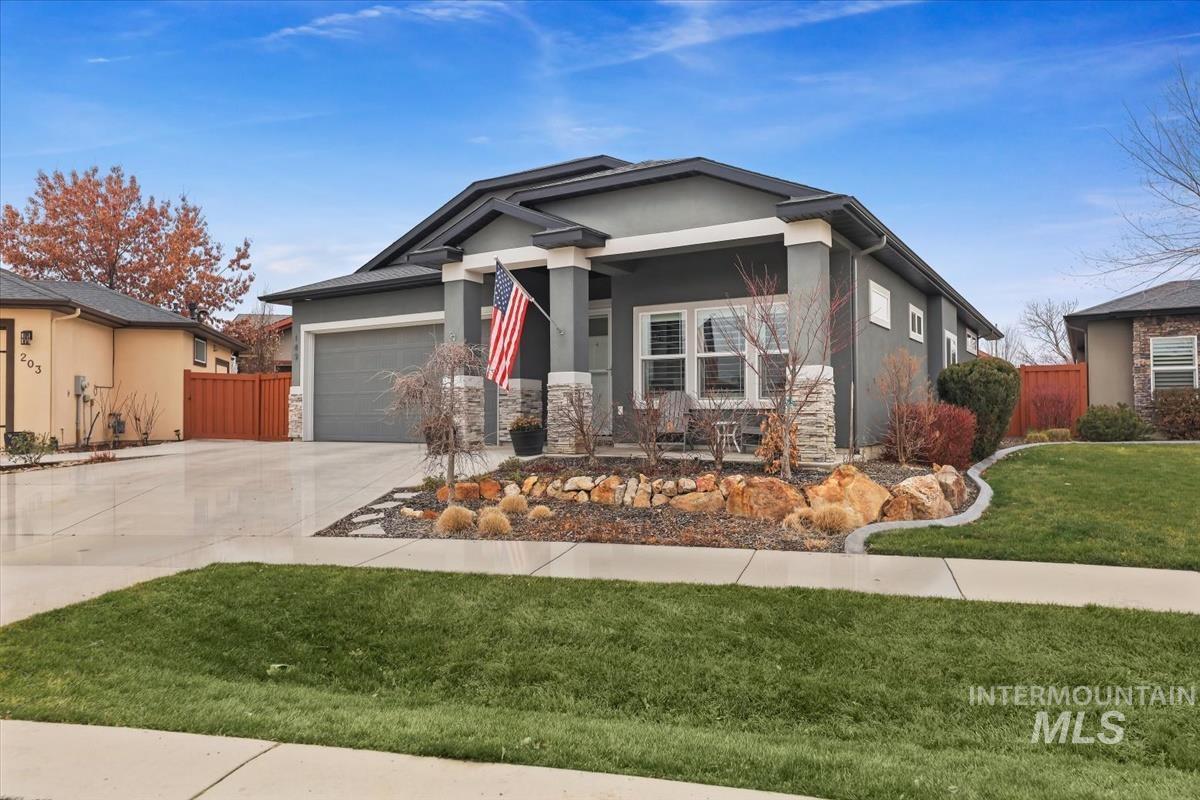 189 South Devon Avenue Star, ID 83669 - Photo 42 of 42 View of front of home with driveway, stucco siding, stone siding, covered porch, and an attached garage