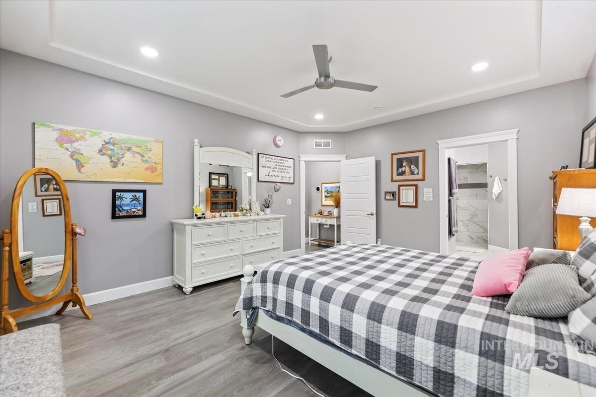 189 South Devon Avenue Star, ID 83669 - Photo 10 of 42 Bedroom featuring light wood finished floors, ceiling fan, ensuite bath, and recessed lighting