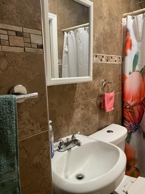 14188 Southwest 145th Place, Unit 1 Miami, FL 33186 - Photo 6 of 6 a bathroom with a sink and mirror