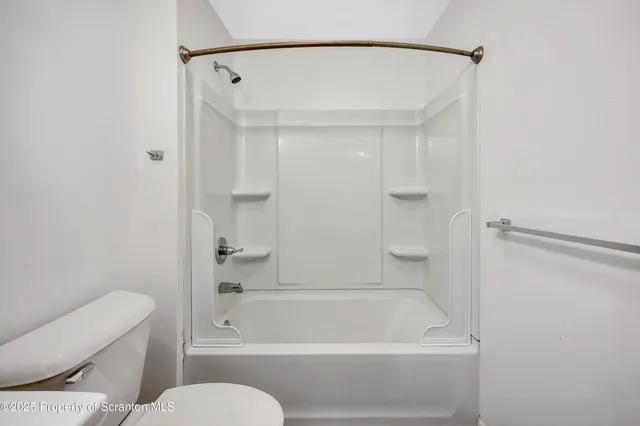 a bathroom with a toilet and a bathtub