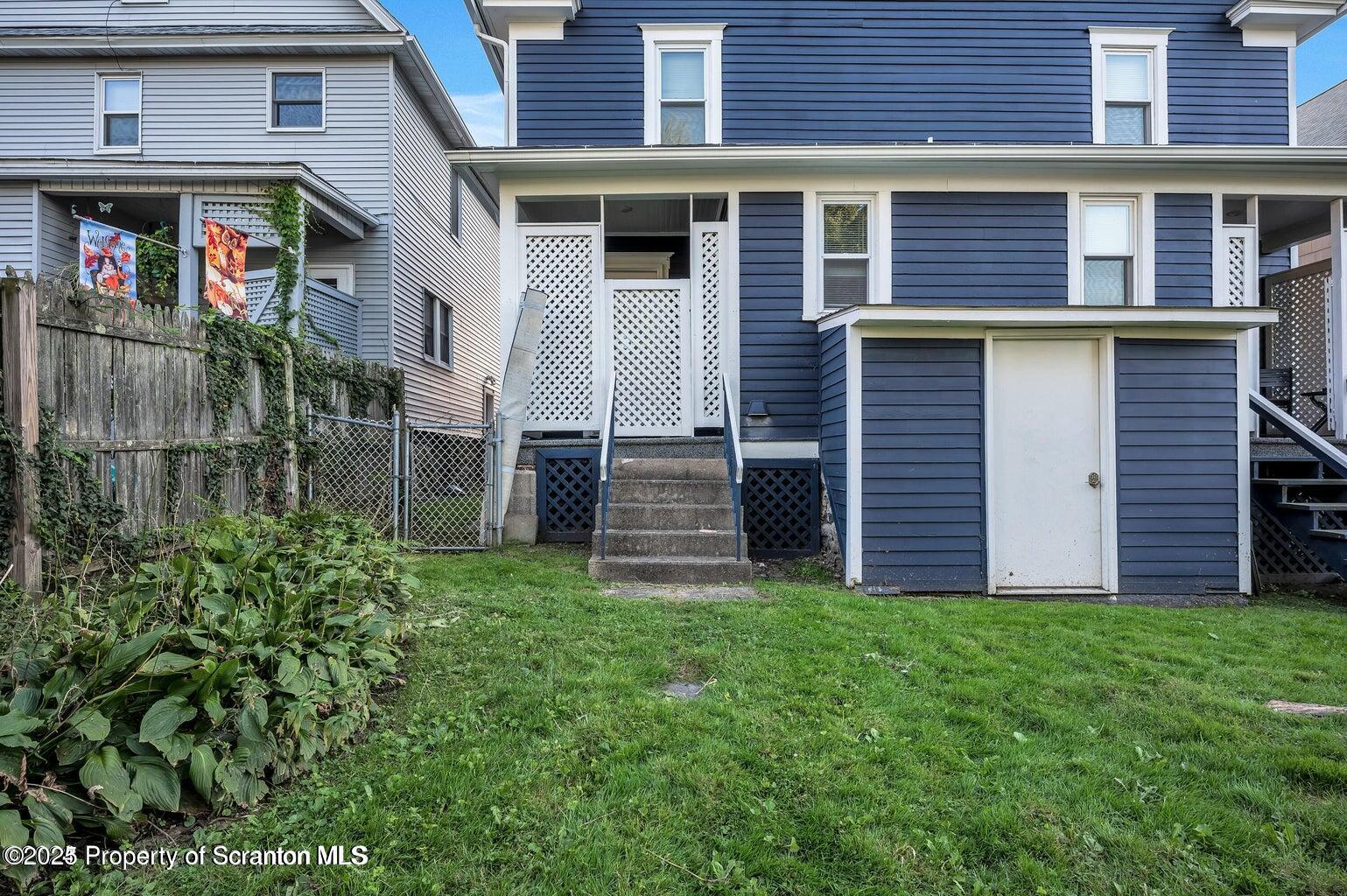 811 Grandview Street Scranton, PA 18509 - Photo 2 of 13 a view of a house with brick walls and a yard with plants