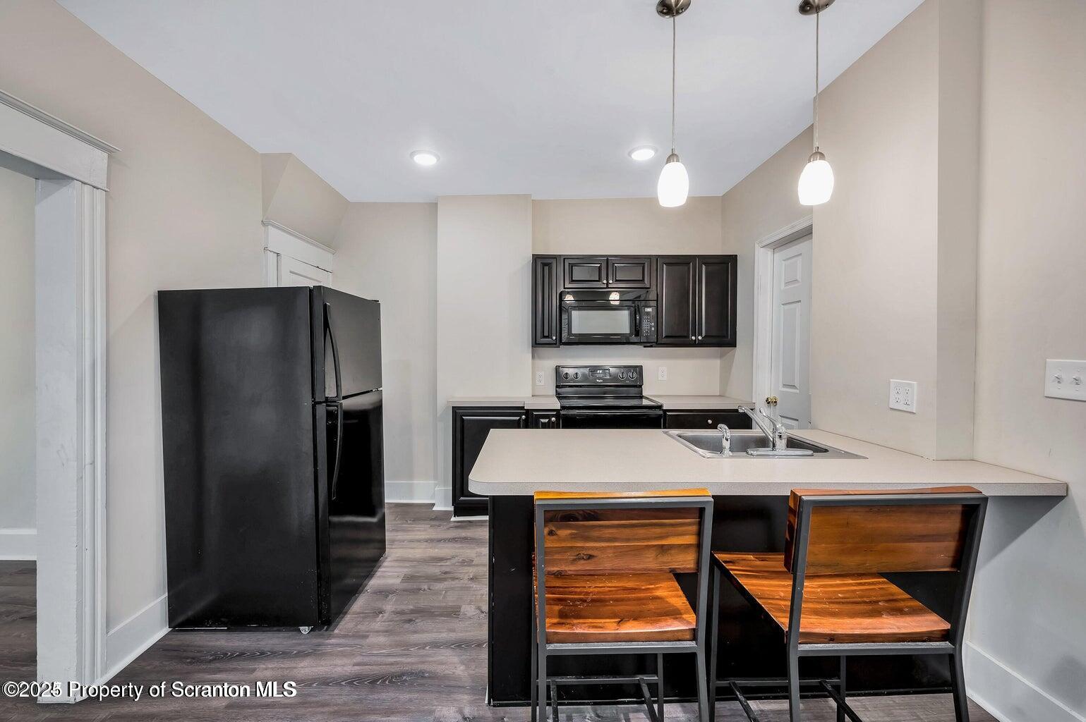 811 Grandview Street Scranton, PA 18509 - Photo 6 of 13 a kitchen with stainless steel appliances granite countertop a refrigerator a sink a stove and a refrigerator