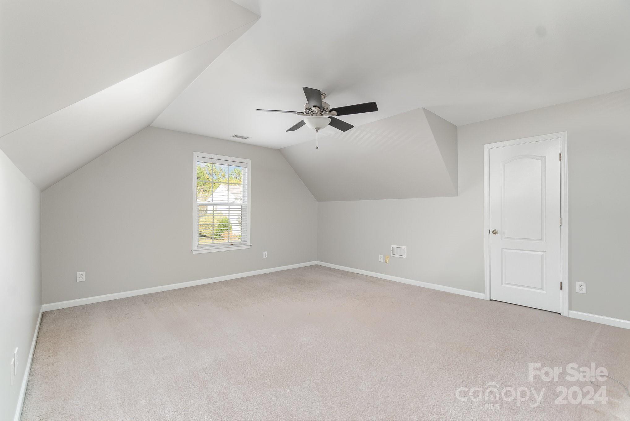 2532 Coltsgate Road Waxhaw, NC 28173 - Photo 16 of 21 an empty room with windows and chandelier fan