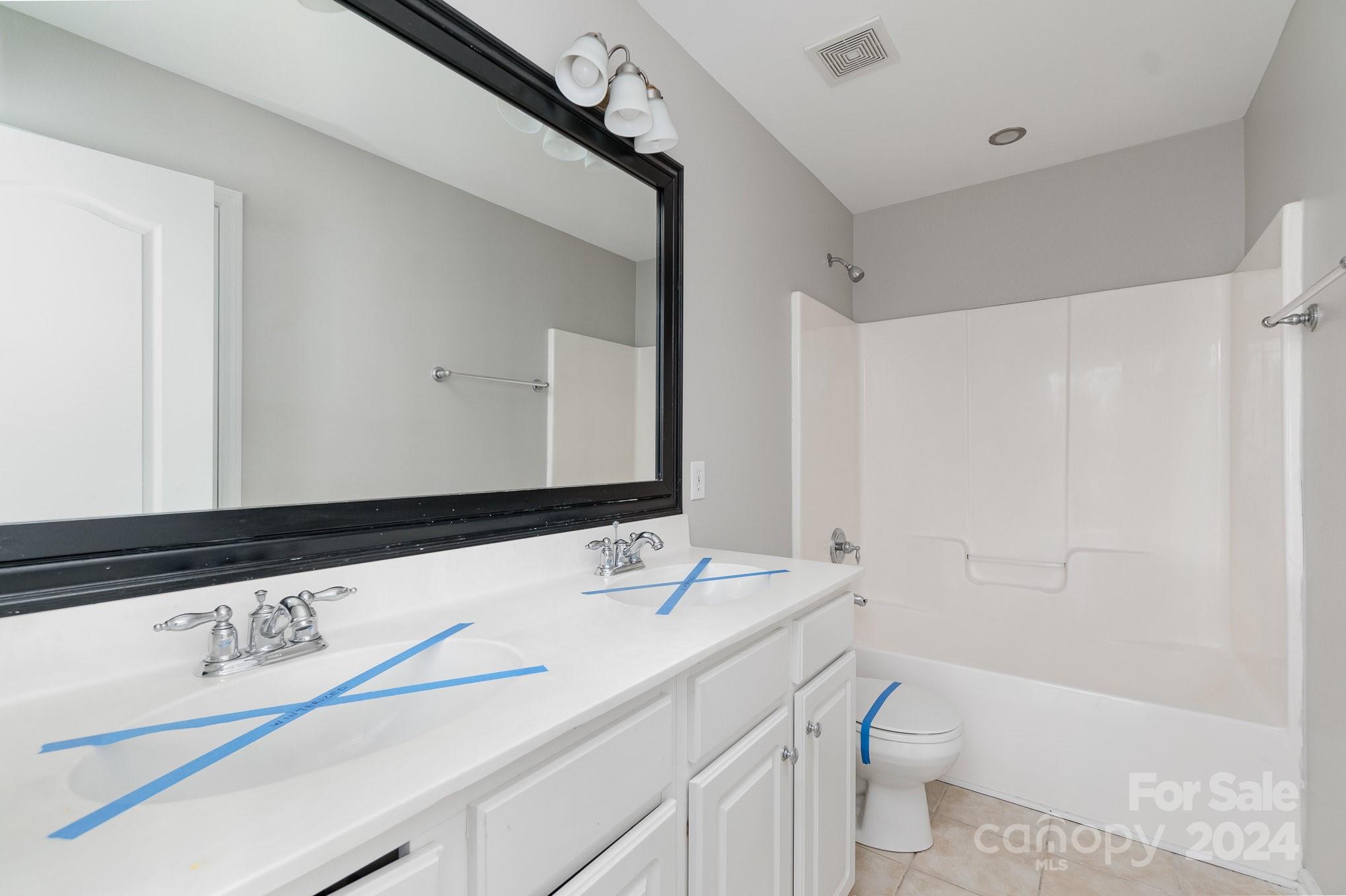 2532 Coltsgate Road Waxhaw, NC 28173 - Photo 17 of 21 a bathroom with a sink a toilet and a bathtub