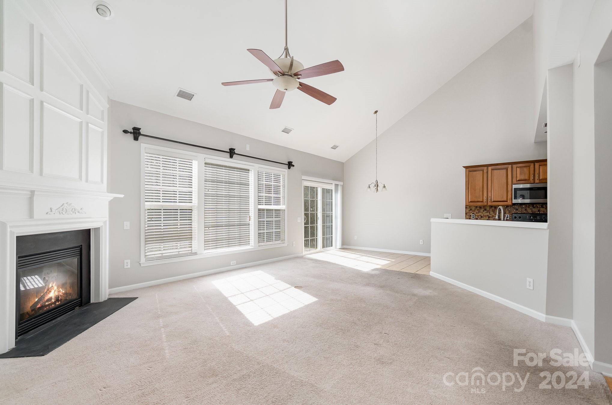 2532 Coltsgate Road Waxhaw, NC 28173 - Photo 7 of 21 a view of an empty room with a fireplace and a window