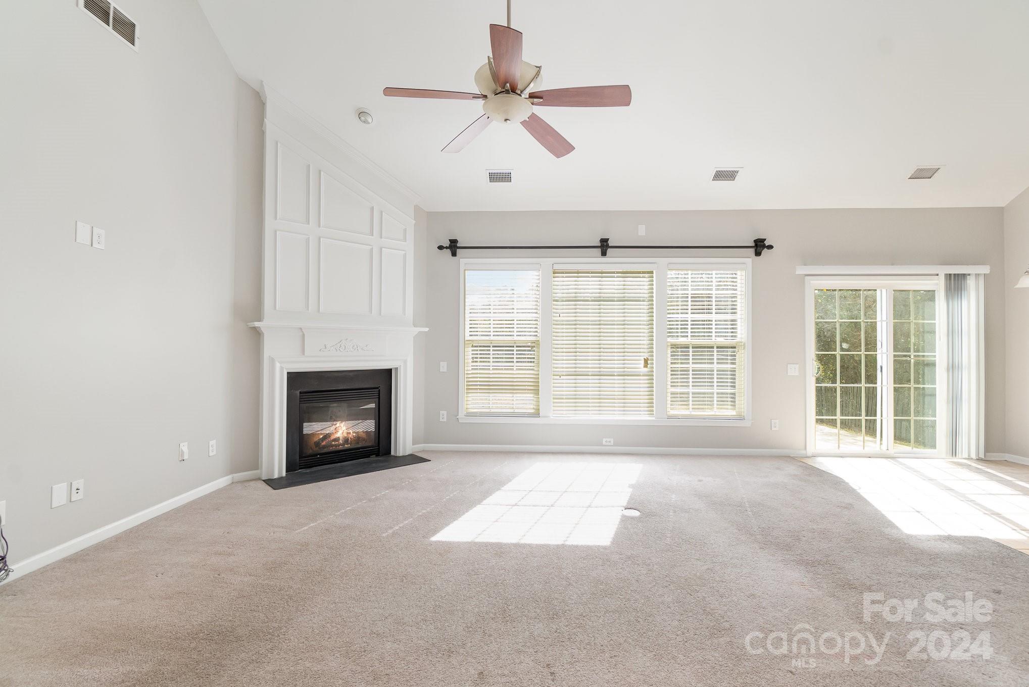 2532 Coltsgate Road Waxhaw, NC 28173 - Photo 9 of 21 a view of an empty room with a fireplace and a window