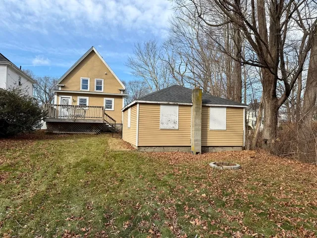 an aerial view of a house with a garden and large trees