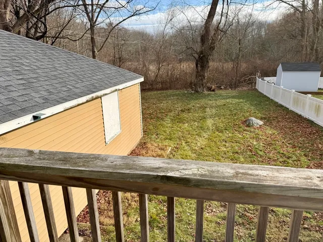 an aerial view of a house with garden space and street view
