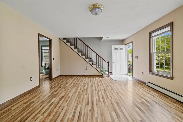 wooden floor in an empty room with a window