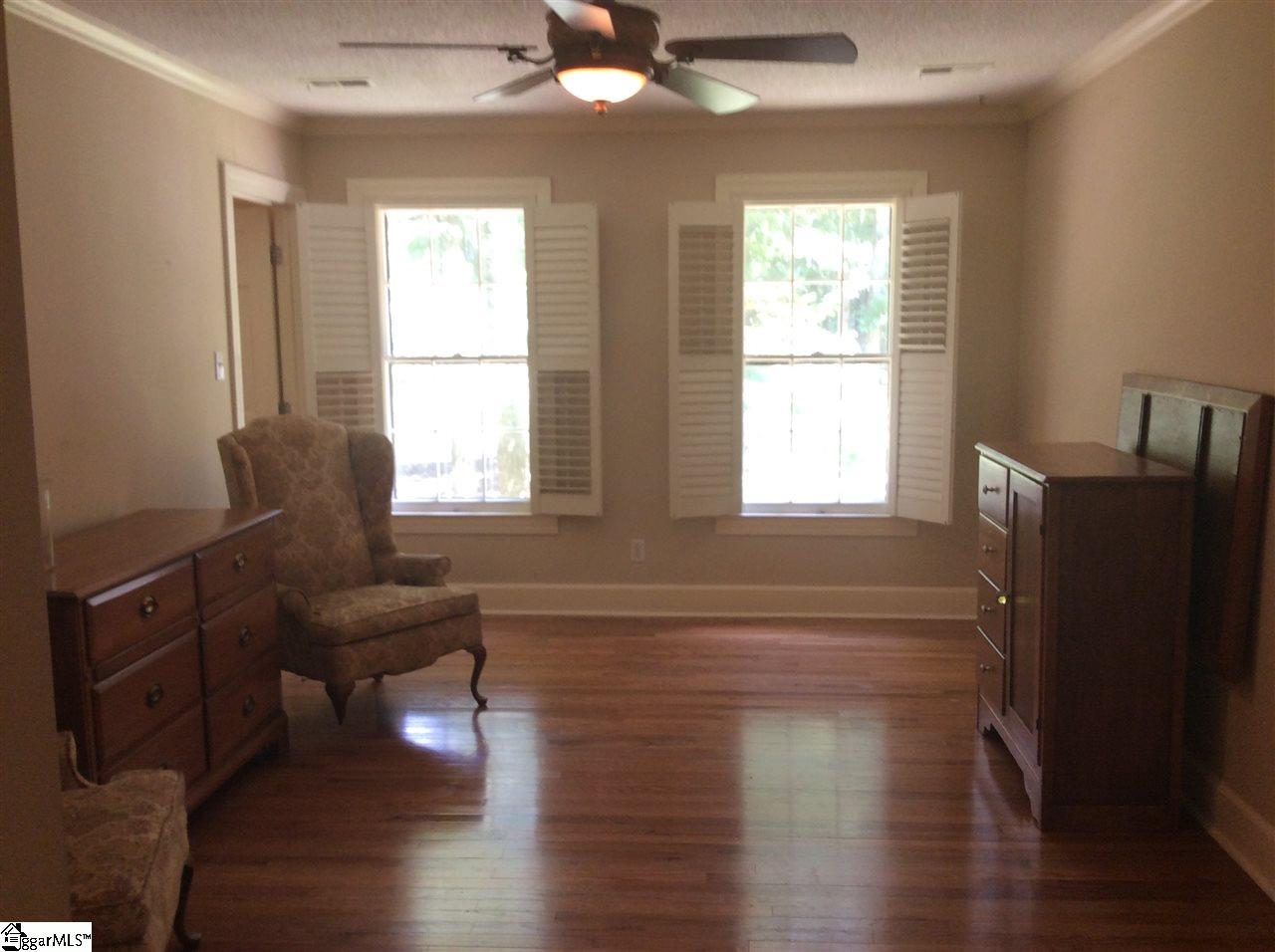 103 Bagwell Farm Road Spartanburg, SC 29302 - Photo 19 of 32 Master bedroom has walk-in closets left of the windows. More hardwood flooring and plantation shutters.