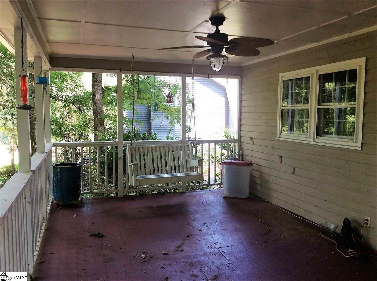 Relax in the porch swing and enjoy your large private yard.