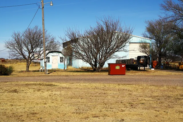 a view of a dining room with furniture and a chandelier