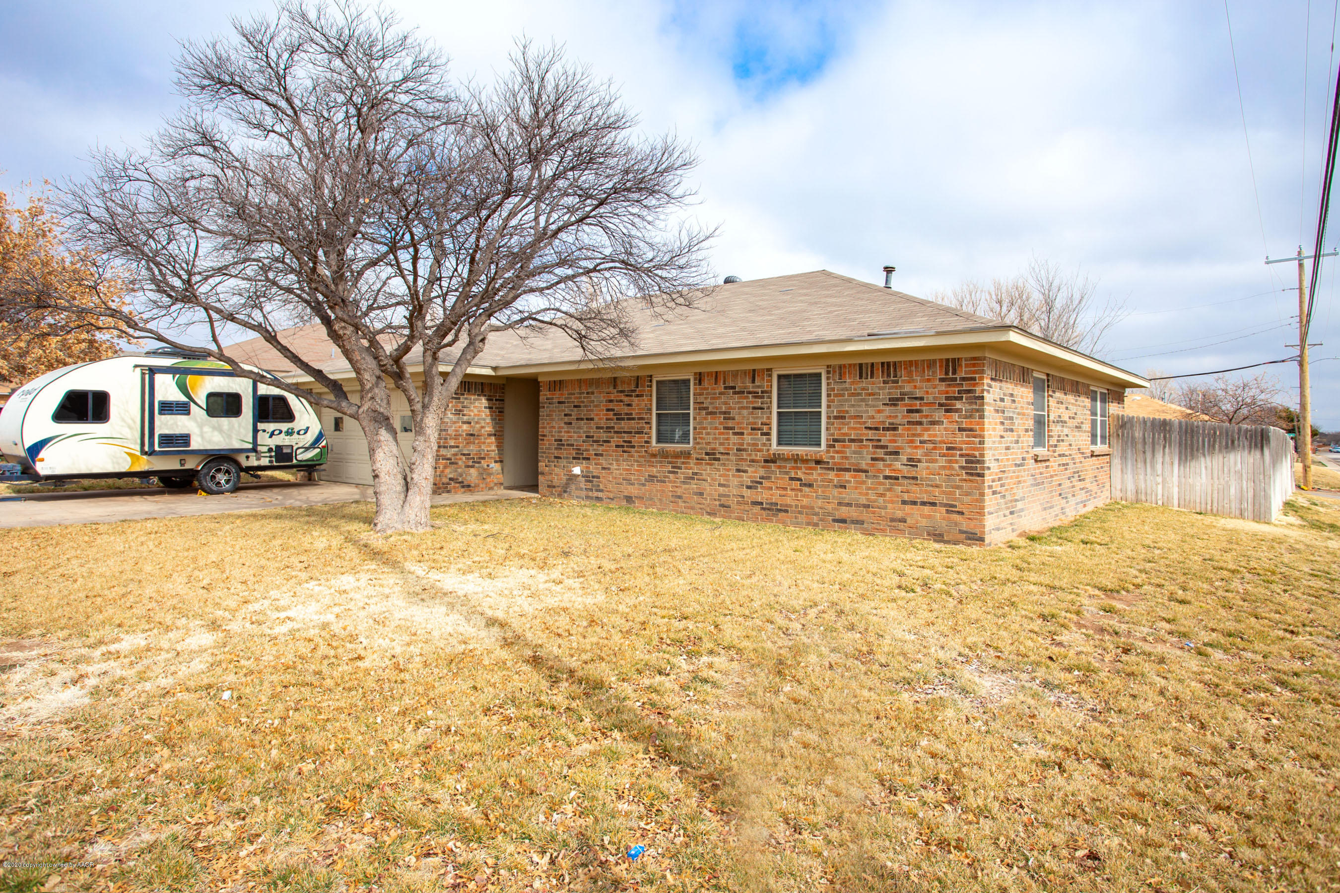8213 Wrangler Trail Amarillo, TX 79110 - Photo 2 of 20 a front view of a house with large trees