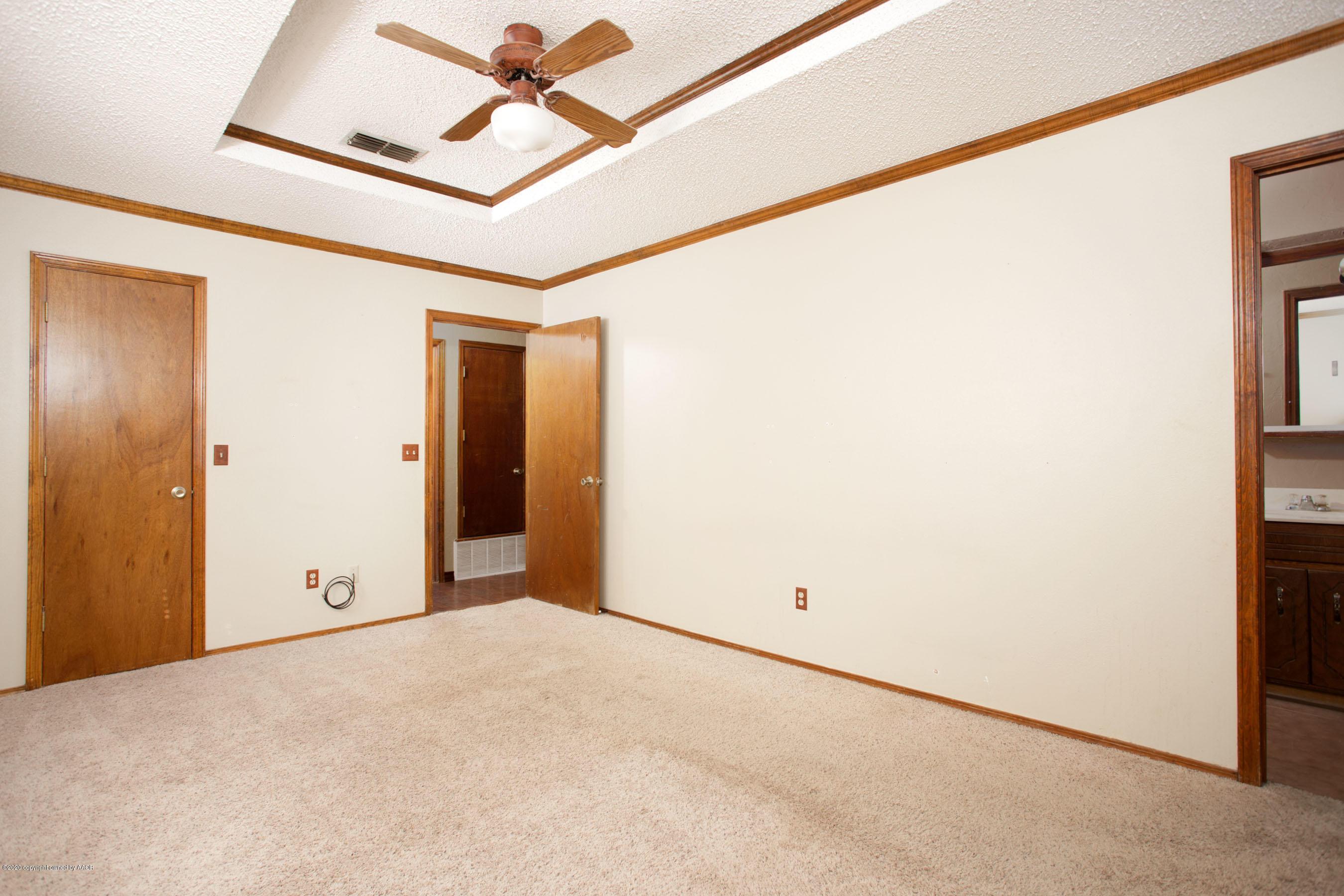 8213 Wrangler Trail Amarillo, TX 79110 - Photo 11 of 20 a view of a room with a walk in closet and wooden floor
