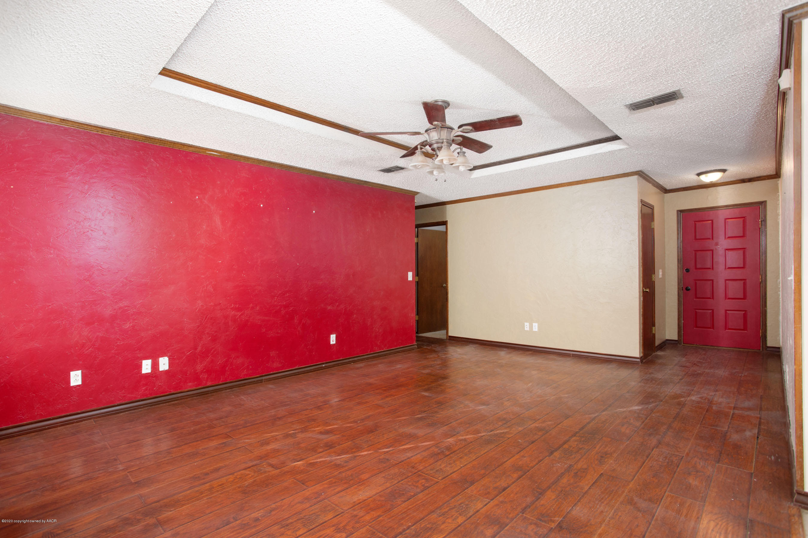 8213 Wrangler Trail Amarillo, TX 79110 - Photo 5 of 20 a view of a big room with wooden floor and chandelier fan
