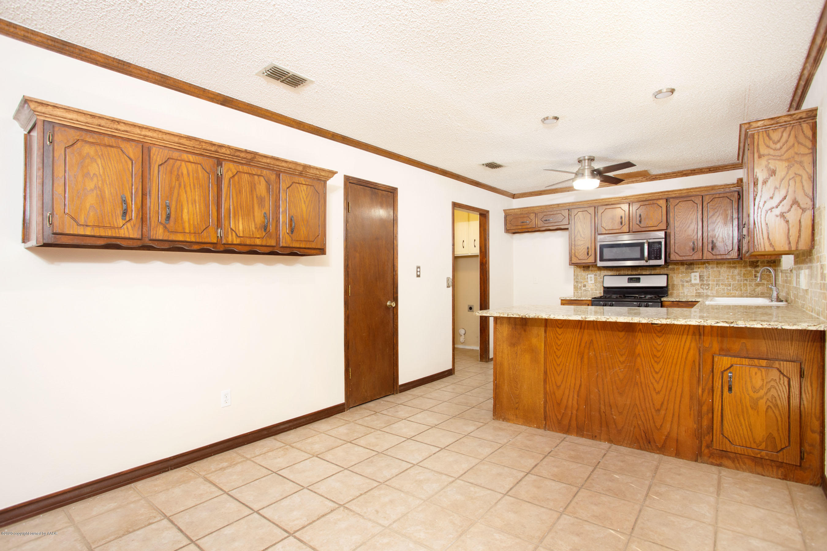 8213 Wrangler Trail Amarillo, TX 79110 - Photo 6 of 20 a kitchen with stainless steel appliances granite countertop a refrigerator and a stove top oven