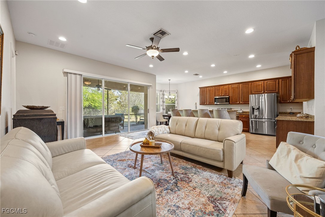 10117 Silver Maple Court Fort Myers, FL 33913 - Photo 16 of 49 a living room with furniture ceiling fan and a view of kitchen
