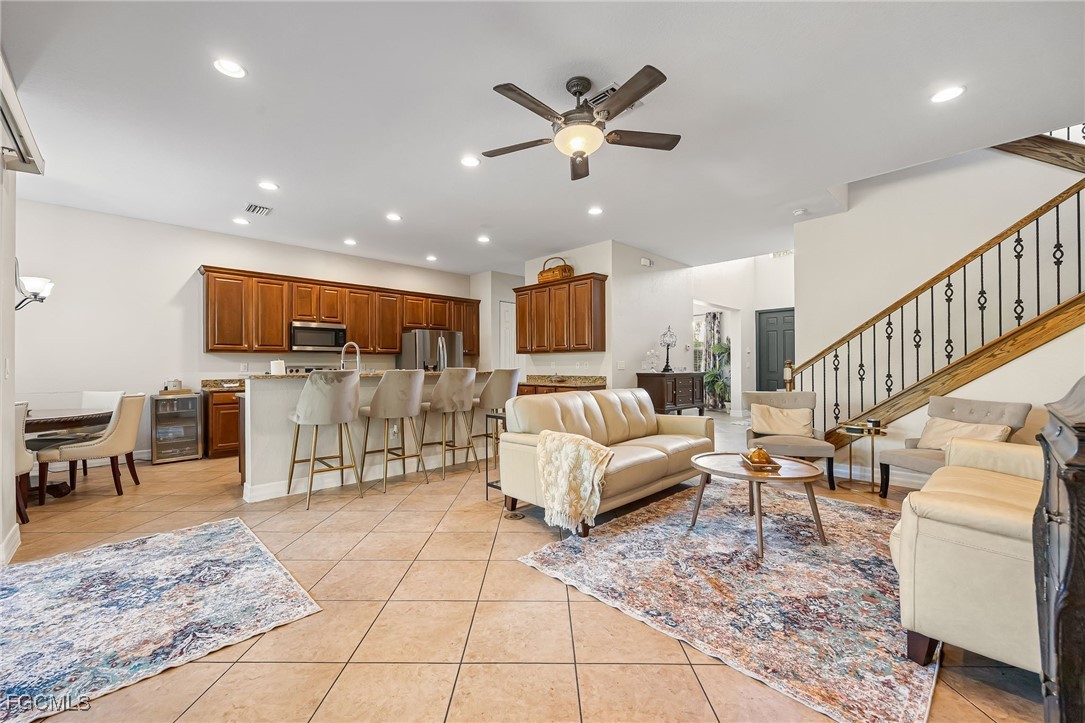 10117 Silver Maple Court Fort Myers, FL 33913 - Photo 17 of 49 a living room with furniture and kitchen view