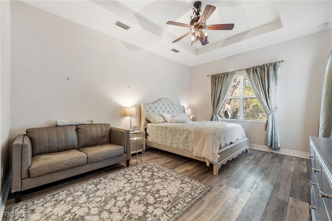 10117 Silver Maple Court Fort Myers, FL 33913 - Photo 19 of 49 a bedroom with a bed couch and window