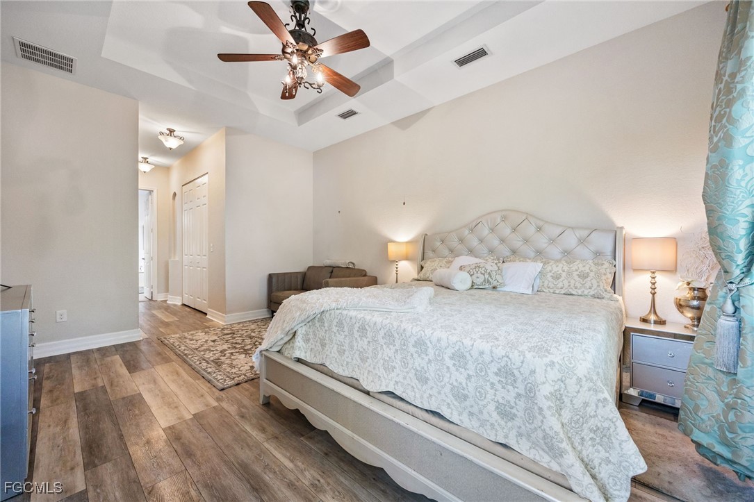 10117 Silver Maple Court Fort Myers, FL 33913 - Photo 20 of 49 a bedroom with a bed and wooden floor