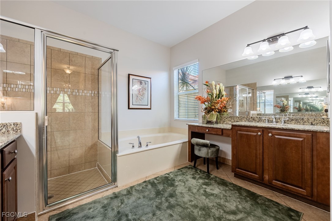 10117 Silver Maple Court Fort Myers, FL 33913 - Photo 21 of 49 a spacious bathroom with a shower a sink and a mirror
