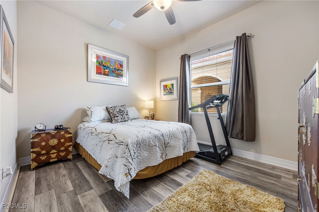 10117 Silver Maple Court Fort Myers, FL 33913 - Photo 22 of 49 a bedroom with bed and a chandelier