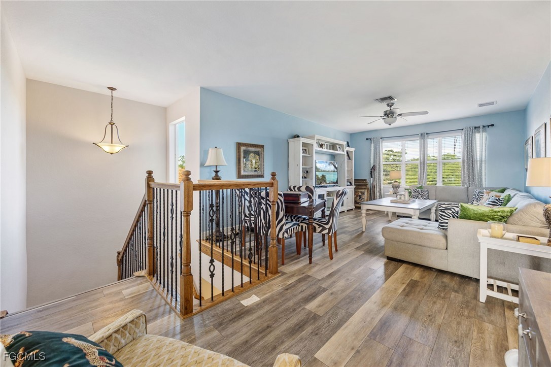 10117 Silver Maple Court Fort Myers, FL 33913 - Photo 24 of 49 a living room with furniture and a wooden floor