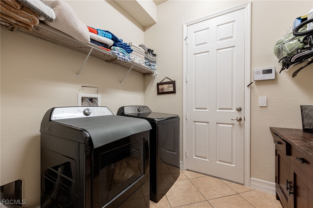 10117 Silver Maple Court Fort Myers, FL 33913 - Photo 31 of 49 a utility room with dryer and washer