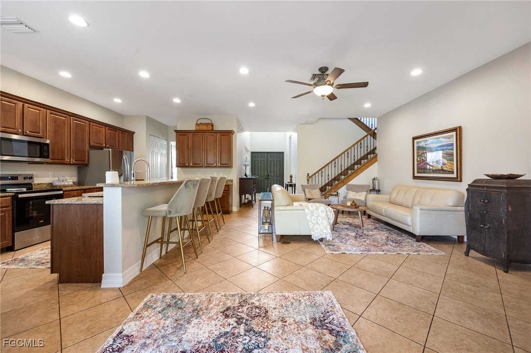 10117 Silver Maple Court Fort Myers, FL 33913 - Photo 10 of 49 a living room with stainless steel appliances furniture and a kitchen view